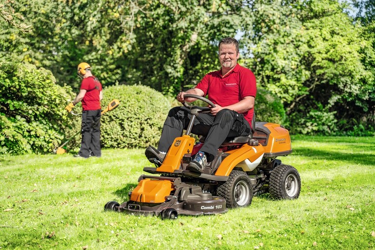 Gardener mows lawn 